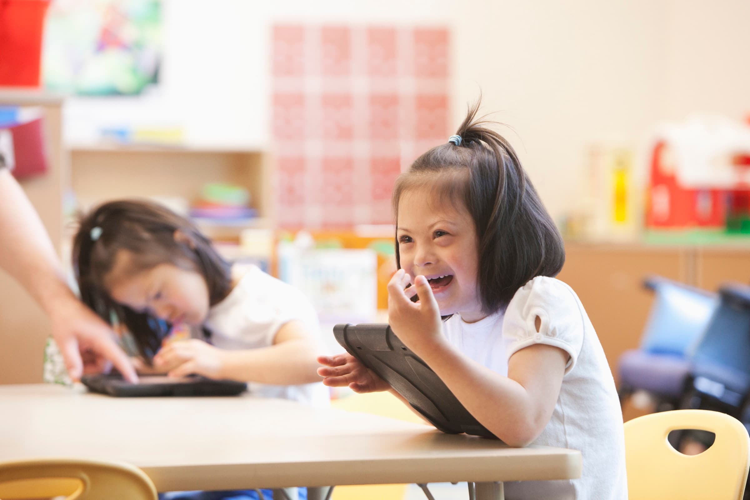 A smiling young student in a classroom